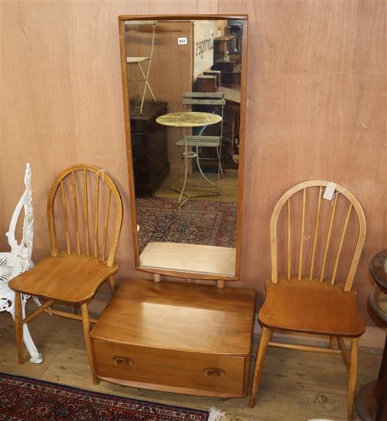 An Ercol elm cheval mirror and two Ercol comb back chairs
